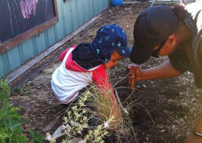 Child and teacher planting