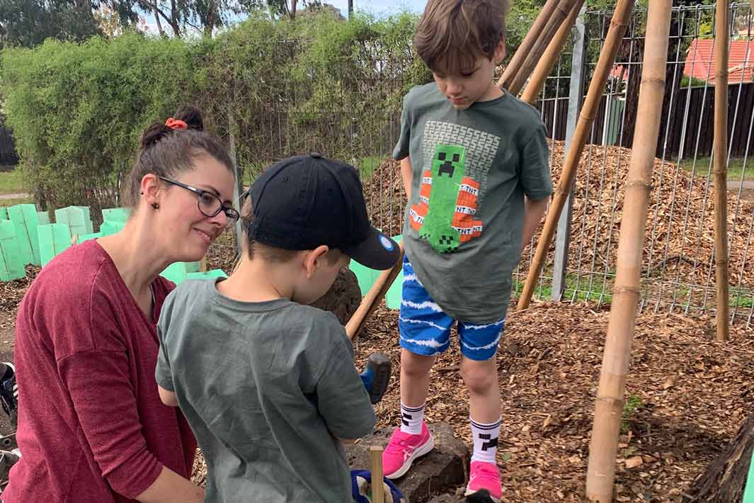 Two students and a teacher in the garden at Apollo Parkways Preschool