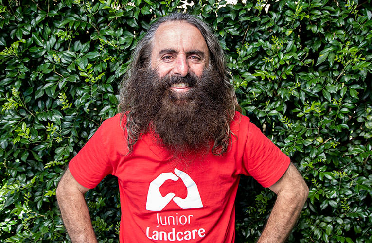 Image Description: Portrait of TV personality Costa Georgiadis wearing a red Junior Landcare T-Shirt