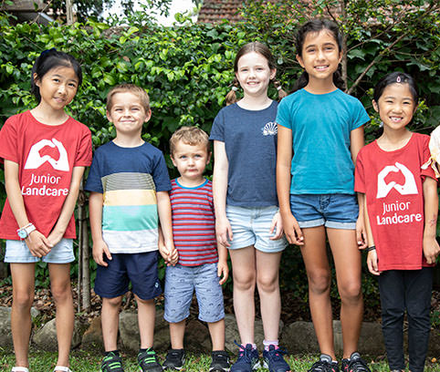 Image Description: Six smiling children in a line.