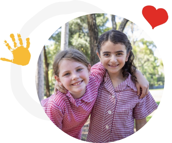 Image Description: Photo of two primary school students kneeling next to garden bed with media personality and Junior Landcare Ambassador Costa Georgiadis.