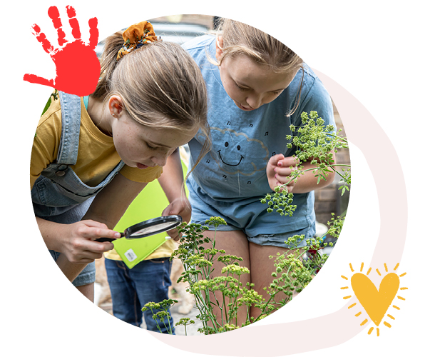 Image Description: Photo of two primary school students kneeling next to garden bed with media personality and Junior Landcare Ambassador Costa Georgiadis.